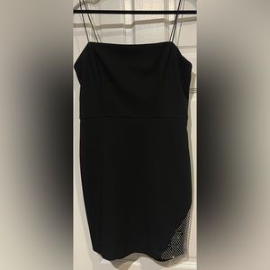 black dress with a simple diamond design on the bottom side of the leg.